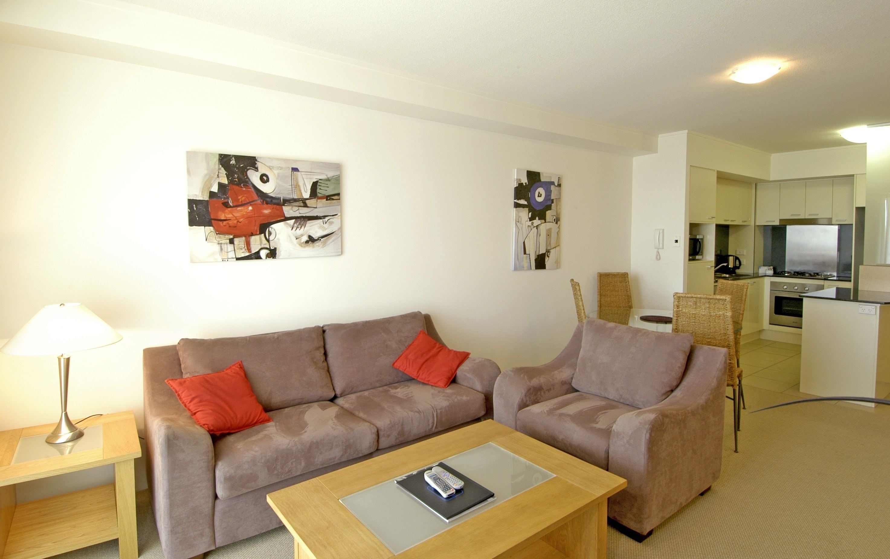 A modern living room with a sofa, a coffee table, and artwork on the walls.