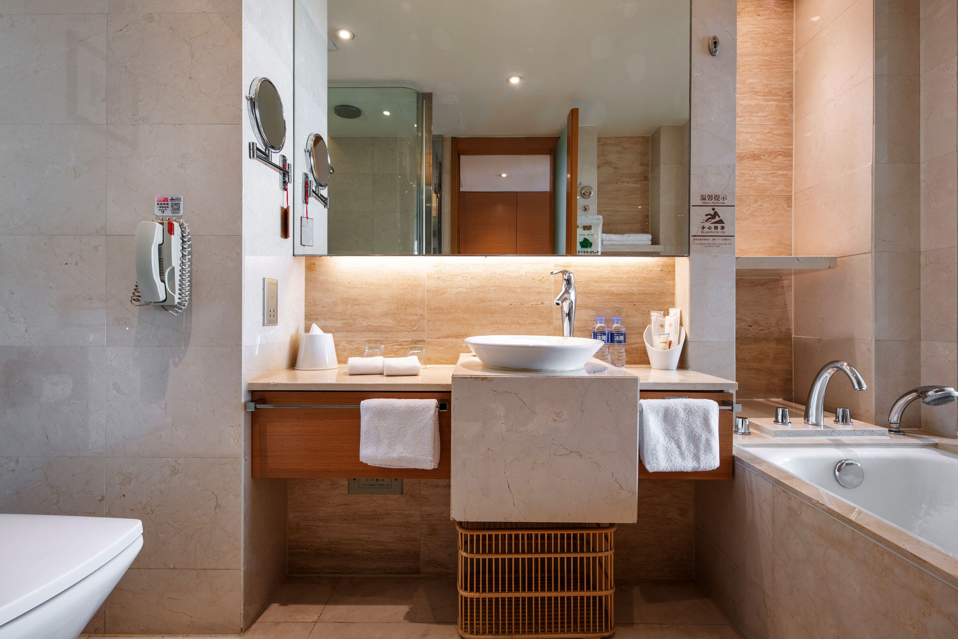 deluxe room | bathroom | combined shower/bathtub, rainfall showerhead, hair dryer, slippers