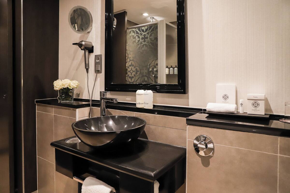executive loft | bathroom | designer toiletries, hair dryer, bathrobes, slippers
