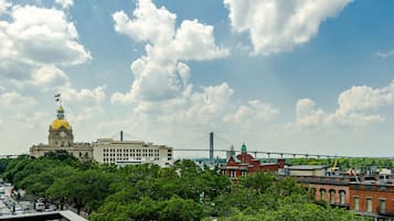 A cityscape with a prominent building featuring a yellow dome and a bridge in the background.