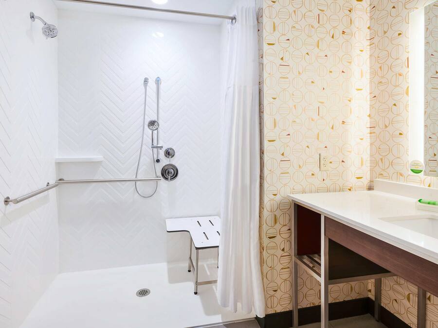 A bathroom with a shower, toilet, and sink.