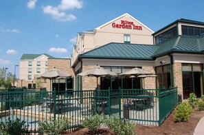 A Hilton Garden Inn with outdoor seating and a stone facade. - Hilton Garden Inn Bowling Green (Bowling Green)