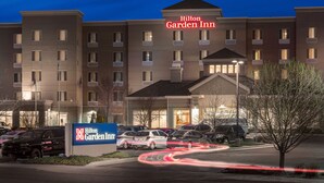 A Hilton Garden Inn with a sign, multiple parking spaces, and a tree in the foreground. - Hilton Garden Inn Billings (Billings)