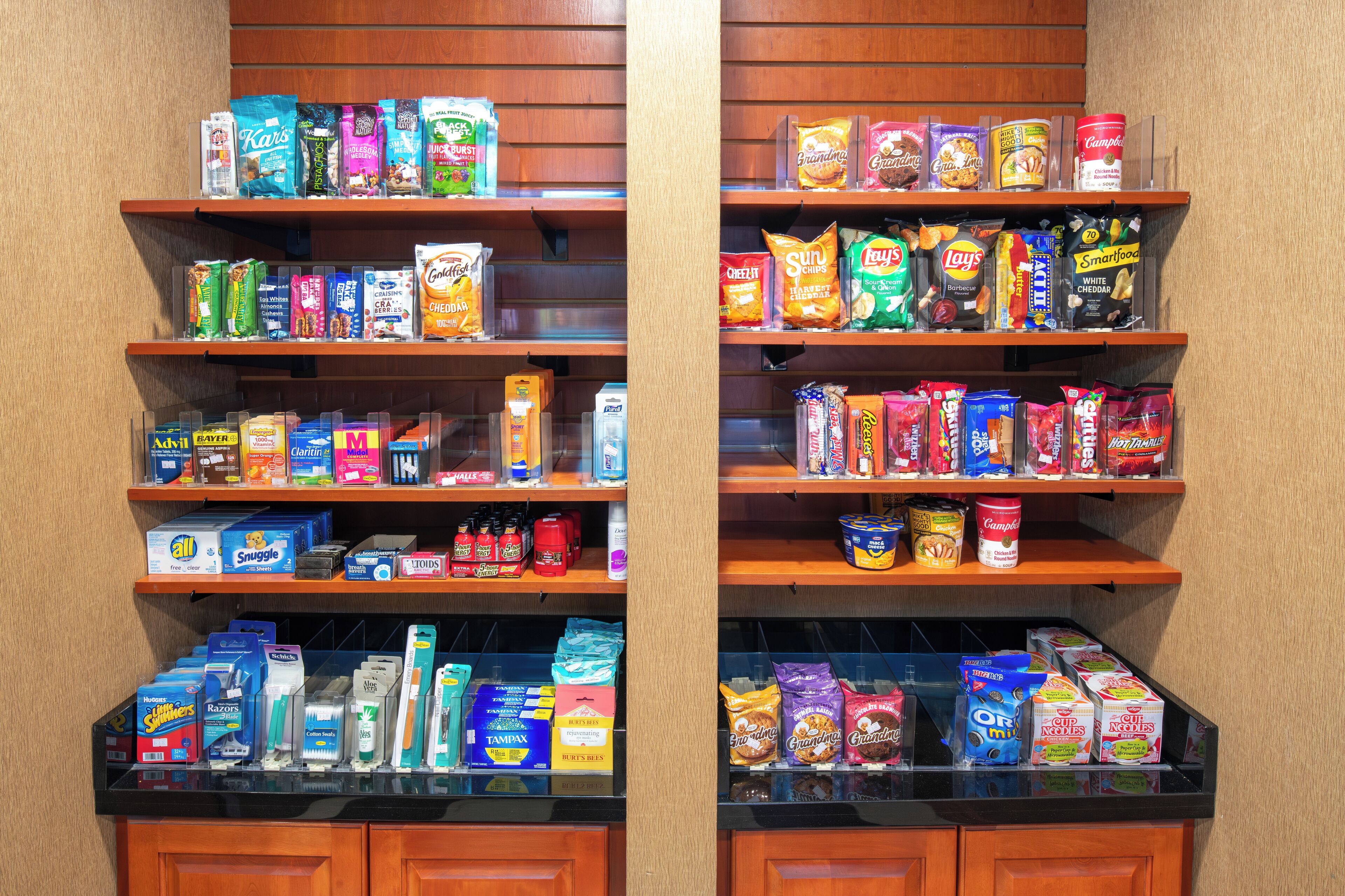 A store with shelves stocked with various snacks, beverages, and personal care items.