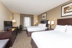A hotel room with two beds, a desk with a TV, a chair, and a lamp. - Holiday Inn Aurora North - Naperville by IHG (Aurora)