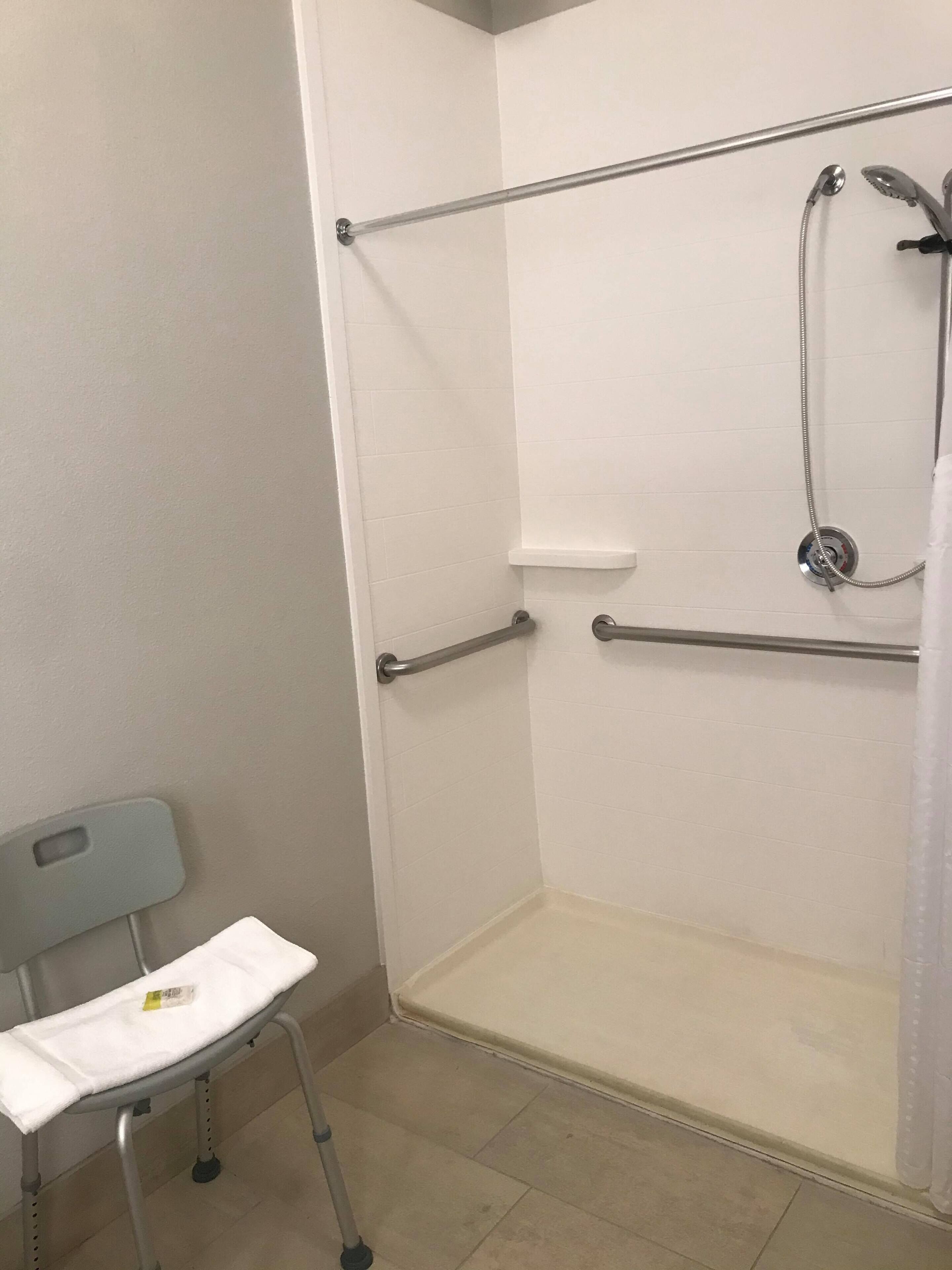 deluxe room, 1 king bed, accessible, non smoking (hearing, roll-in shower) | bathroom | combined shower/bathtub, hair dryer, towels