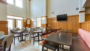 A spacious indoor dining area with high ceilings, large windows, and a variety of seating options including tables and booths. - Drury Inn & Suites Las Cruces (Las Cruces)