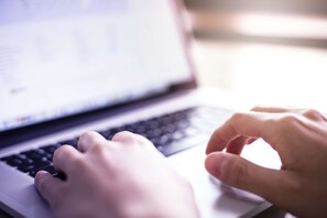 A close-up of hands typing on a laptop keyboard. - La Quinta Inn & Suites by Wyndham Ruidoso Downs (Ruidoso Downs)
