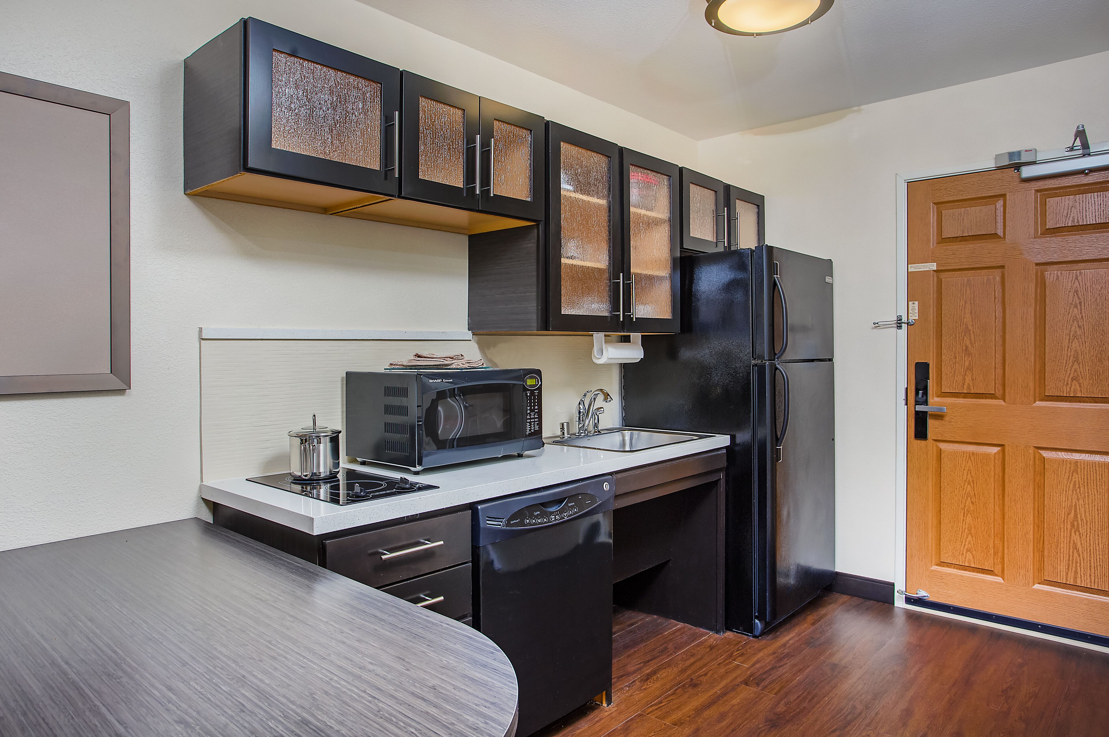 full-sized fridge, microwave, stovetop, dishwasher