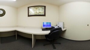 A small office with a curved desk, a computer, and a framed map on the wall. - Candlewood Suites Warner Robins/Robins AFB by IHG (Warner Robins)