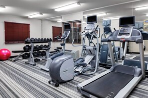 A gym with treadmills, elliptical machines, a bench press, and a rack of dumbbells. - Candlewood Suites Warner Robins/Robins AFB by IHG (Warner Robins)