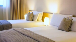 A hotel room with two beds, each with a duvet and pillows. - The Louis Fitzgerald Hotel (Dublin)