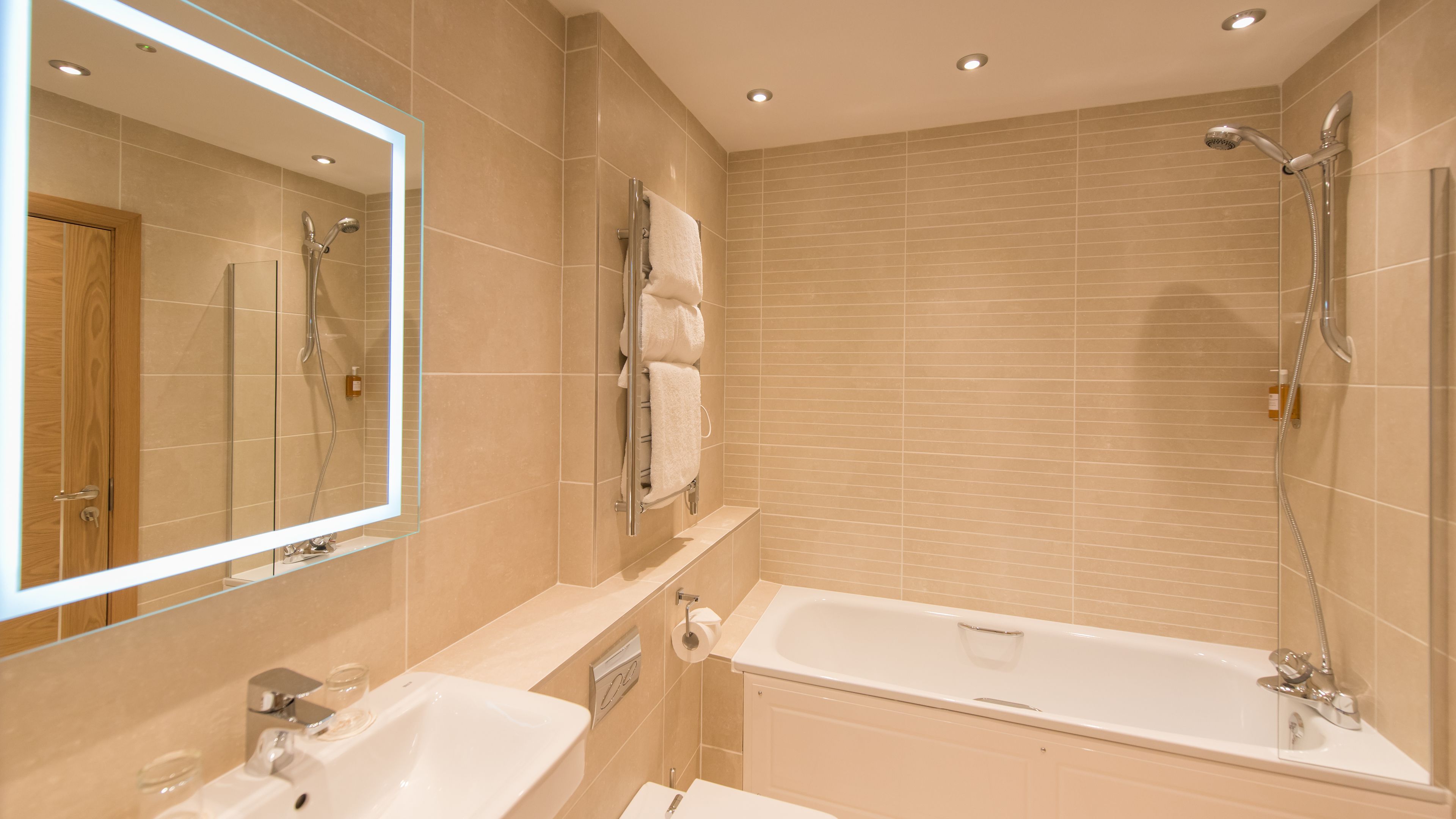 combined shower/bathtub, designer toiletries, hair dryer, towels