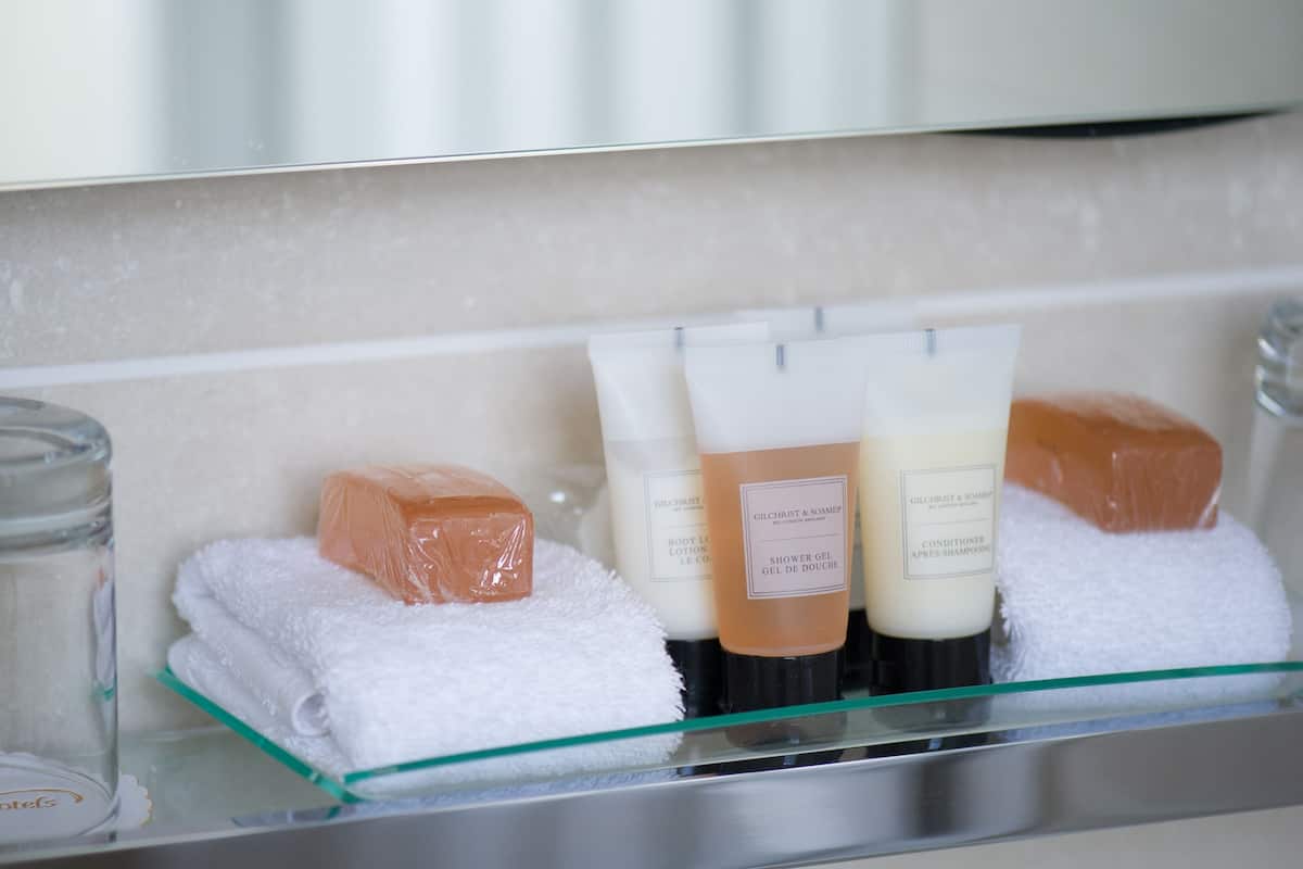 combined shower/bathtub, designer toiletries, hair dryer, towels