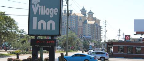 A Village Inn sign with a digital display indicating room availability.