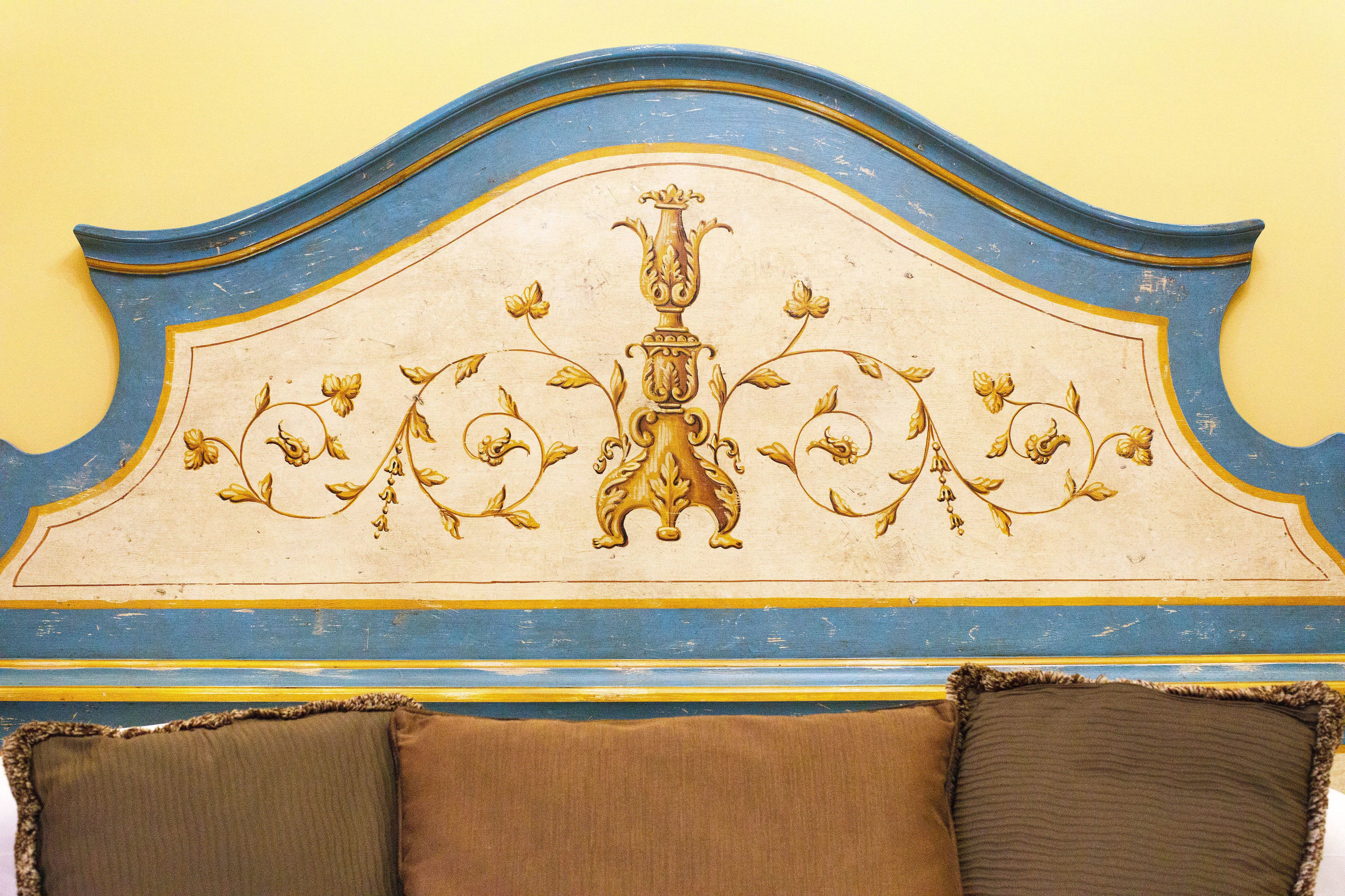 A headboard with a decorative design and two pillows.