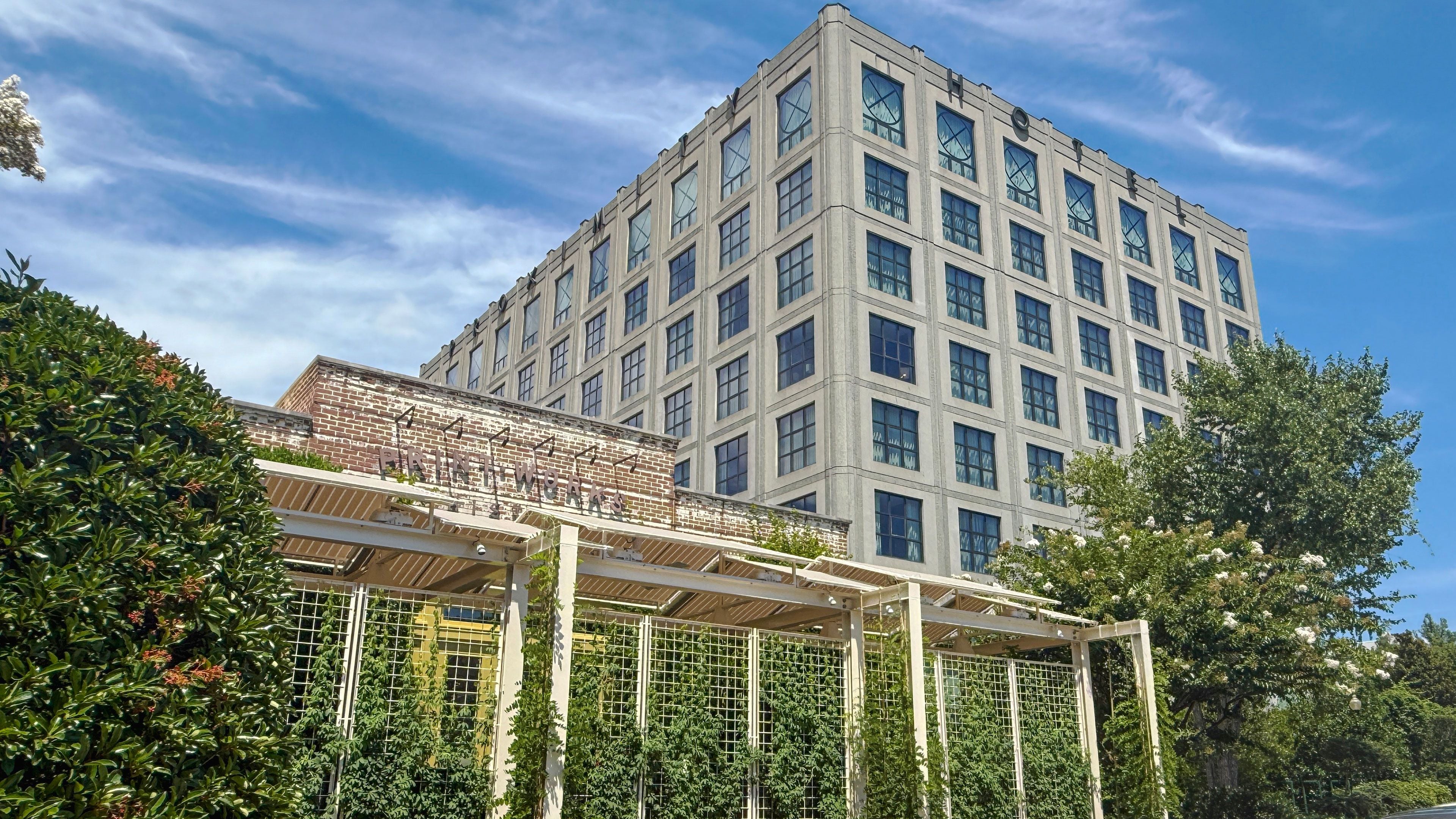 A multi-story building with a brick facade and large windows.