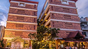 A multi-story building with a traditional architectural style, featuring a prominent entrance with decorative elements and a sign that reads "Daming Lodge."