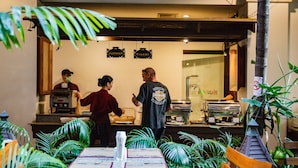 A restaurant with a counter, a menu, and a sign indicating it offers pastries and bakery.