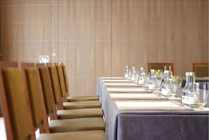 Enjoy a formal dining experience with a beautifully set table and comfortable seating.