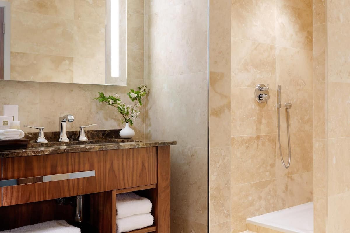 panoramic studio suite, 1 king bed, lake view | bathroom | rainfall showerhead, designer toiletries, hair dryer, bathrobes