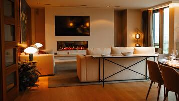 A modern living room with a sofa, a coffee table, and a fireplace.
