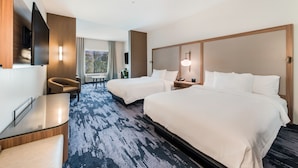 A hotel room with two beds, a desk, a chair, a TV, and a window with curtains. - Fairfield Inn & Suites by Marriott Knoxville Clinton (Andersonville)