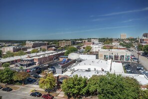 An aerial view of a cityscape with various buildings, parking lots, and streets. - Hilton Columbia Center (Columbia)