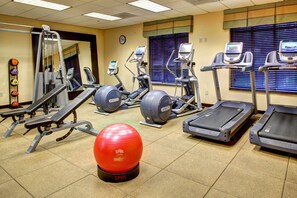 A gym with treadmills, elliptical machines, and a red exercise ball. - Hilton Columbia Center (Columbia)