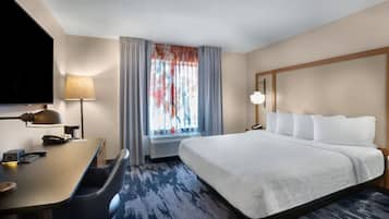 Premium bedding, desk, laptop workspace, blackout drapes