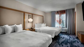 Premium bedding, desk, laptop workspace, blackout drapes