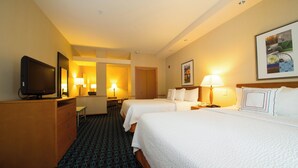 A hotel room with two beds, a desk, a television, and a bathroom visible through an open door. - Fairfield Inn & Suites by Marriott Cordele (Cordele)
