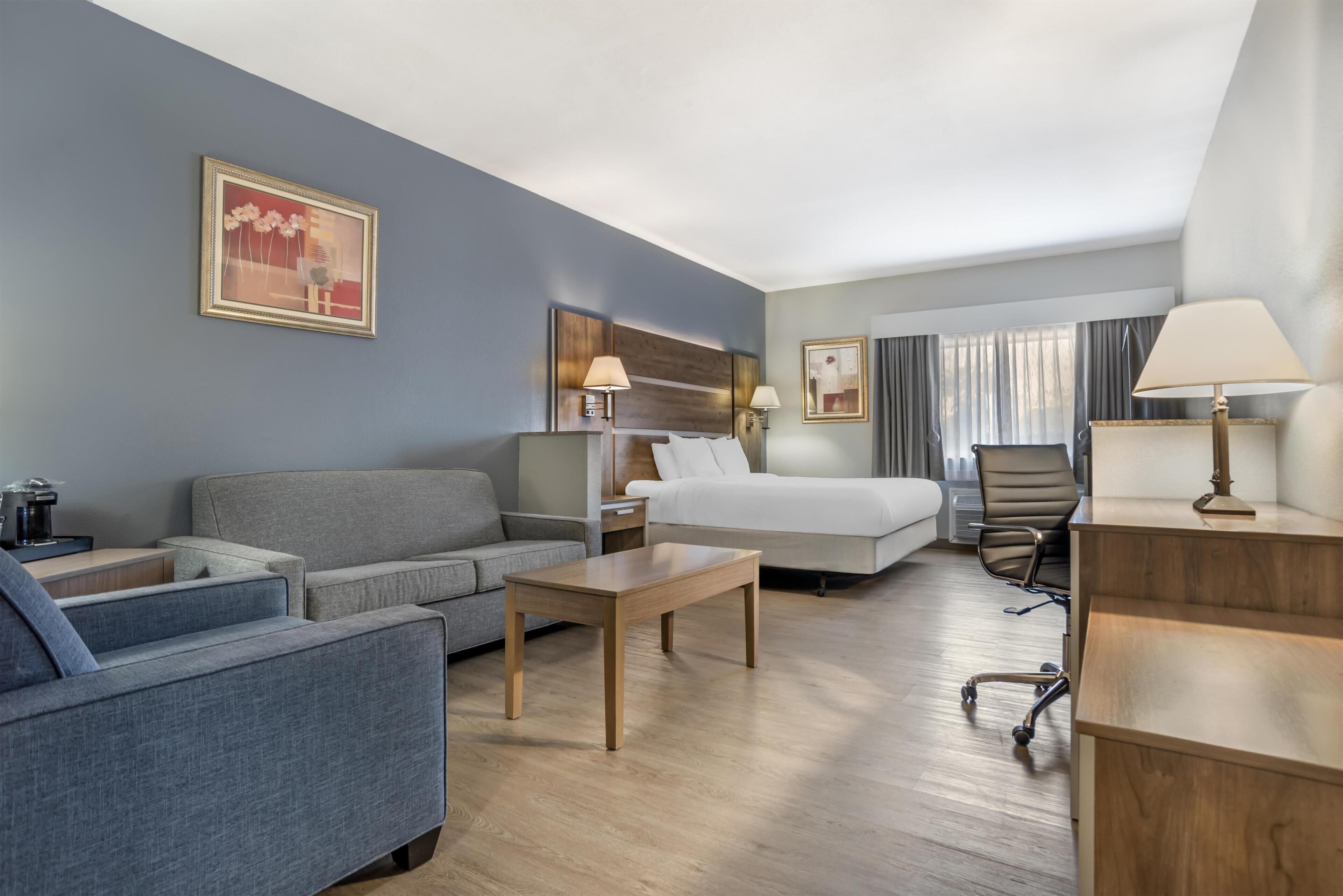 Premium bedding, desk, laptop workspace, blackout drapes