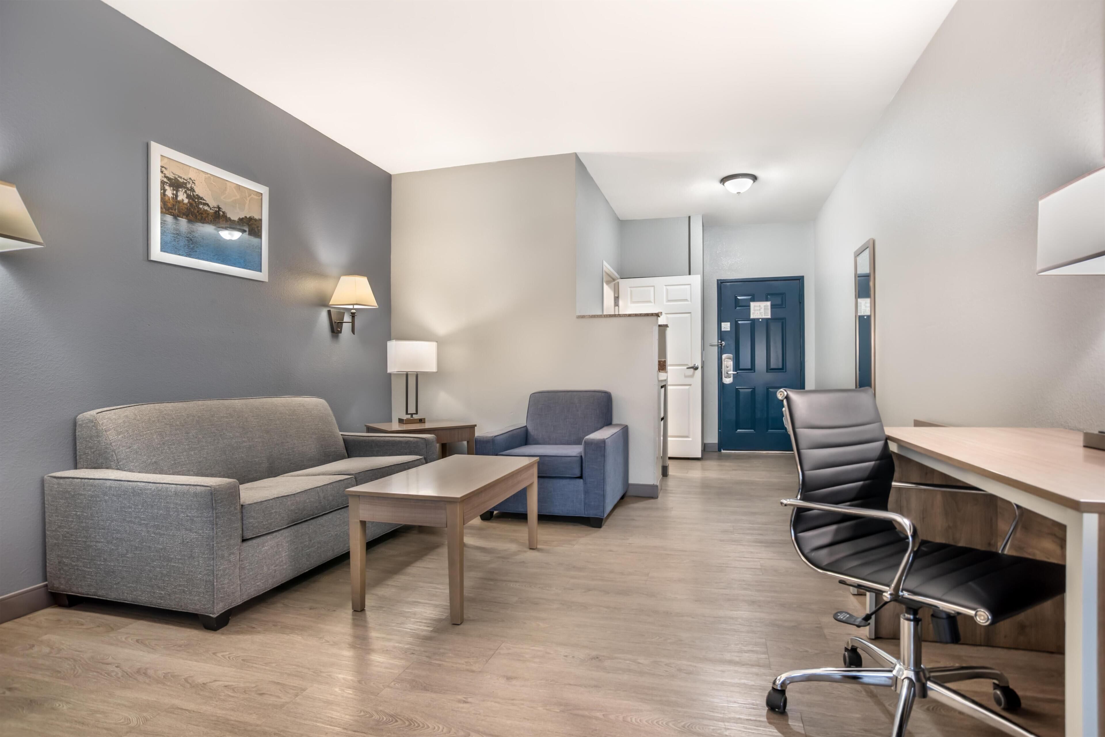 Premium bedding, desk, laptop workspace, blackout drapes