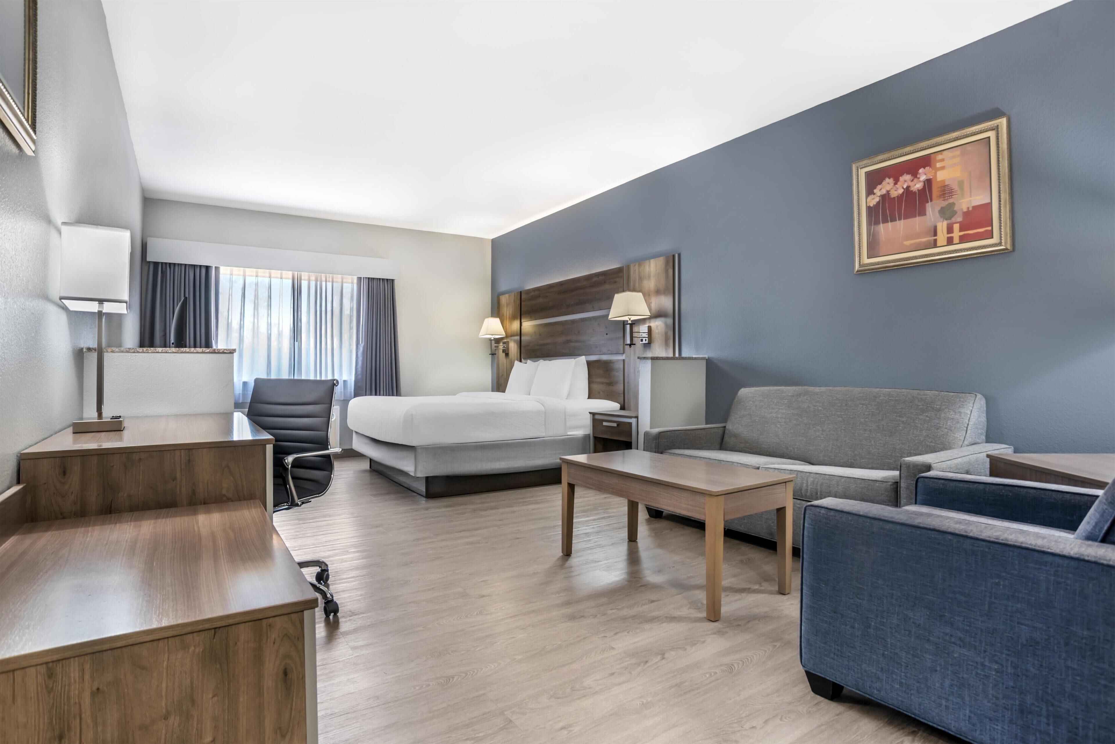 Premium bedding, desk, laptop workspace, blackout drapes