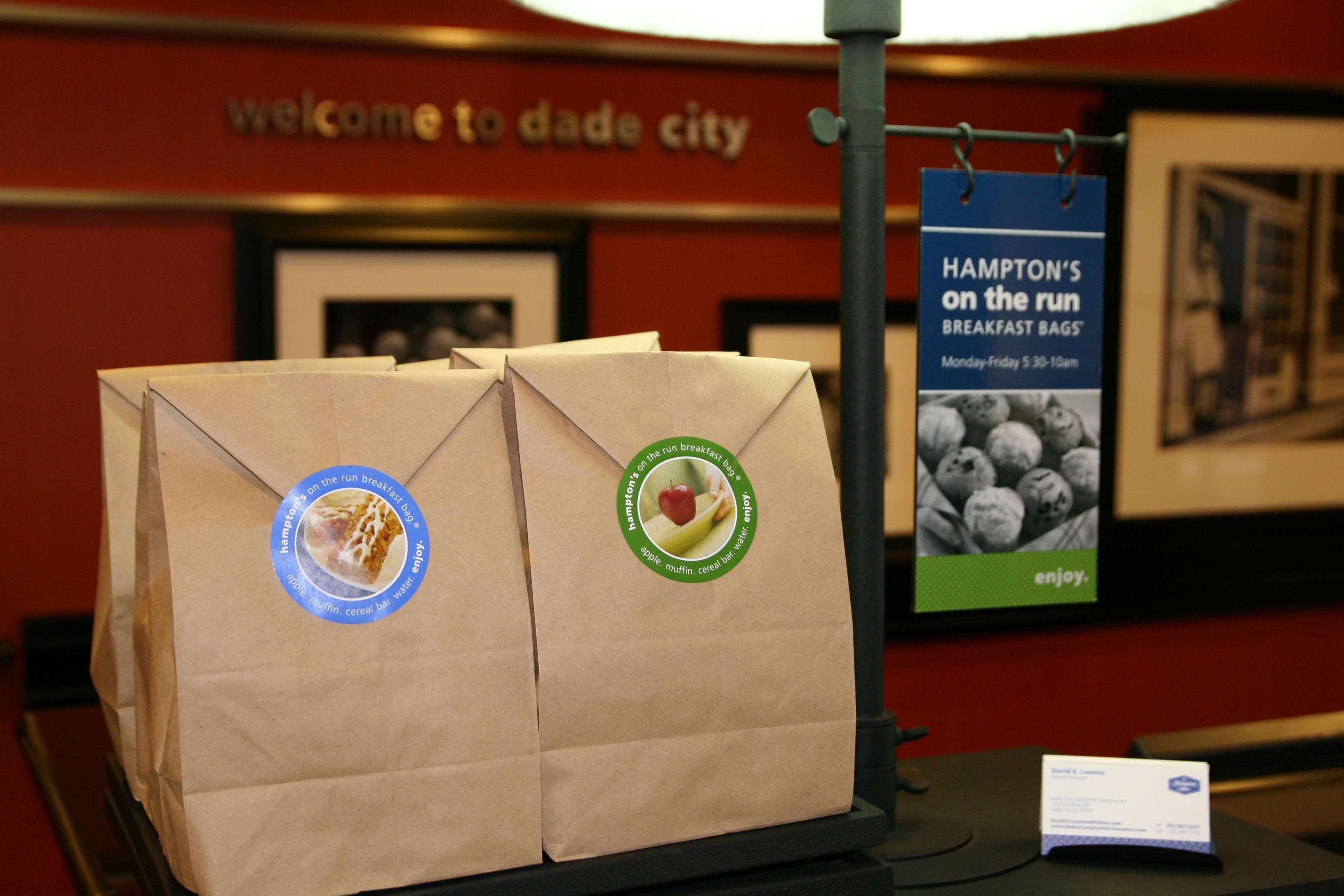 A display of Hampton's on the run breakfast bags with a sign in the background.