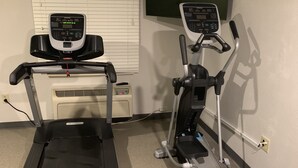 A home gym with a treadmill and an elliptical machine. - WoodSpring Suites Charlotte Shelby (Shelby)