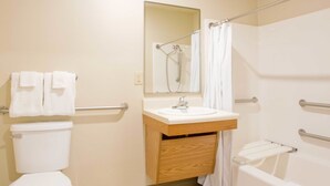 A bathroom with a toilet, sink, and bathtub. - WoodSpring Suites Charlotte Shelby (Shelby)
