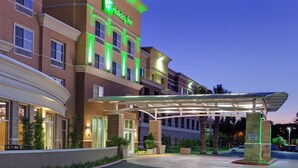 A Holiday Inn hotel with a covered entrance, multiple floors, and a well-lit facade. - Holiday Inn Ontario Airport by IHG (Ontario)