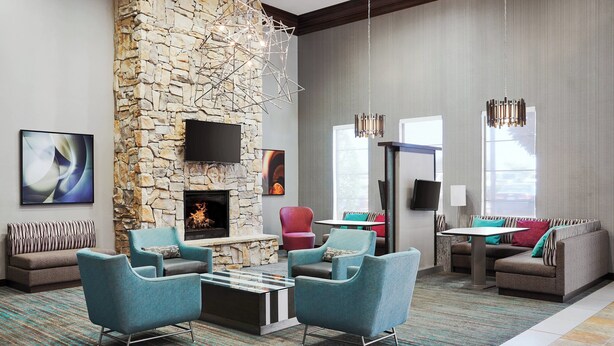 A modern living room with a stone wall, a fireplace, and contemporary furniture. - Residence Inn by Marriott Killeen (Killeen)