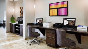 A hotel reception desk with two computer monitors, a printer, and a sign indicating the hotel name. - Residence Inn by Marriott Killeen (Killeen)