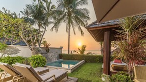 A poolside area with lounge chairs, a small pool, and a view of the sunset over the ocean. - The Sunset Beach Resort & Spa Taling Ngam (Koh Samui)