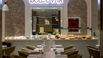 A restaurant interior with a counter displaying desserts and a menu stand.