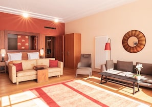 A modern living room with a sofa, armchairs, a coffee table, and a fireplace. - Schloss Elmau Luxury Spa Retreat & Cultural Hideaway (Kruen)