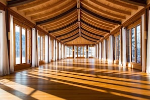 A spacious room with a high ceiling and large windows. - Schloss Elmau Luxury Spa Retreat & Cultural Hideaway (Kruen)