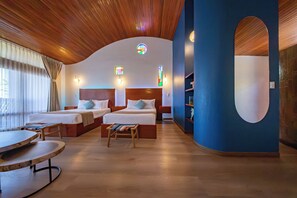 A hotel room with two beds, a wooden ceiling, a large mirror, and a round table. - Xandari Resort And Spa (San Isidro)