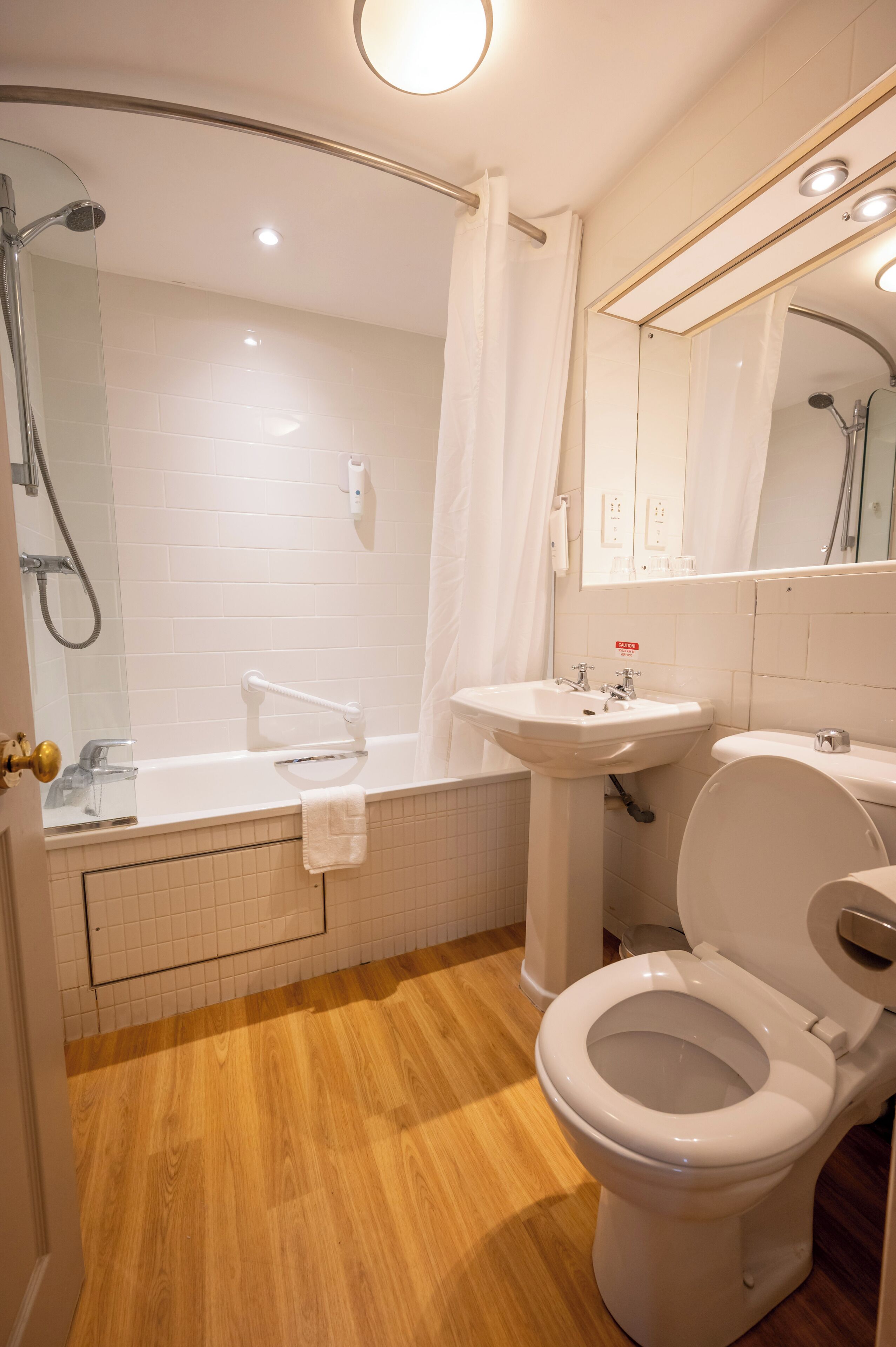 A bathroom with a bathtub, a sink, a toilet, and a shower.