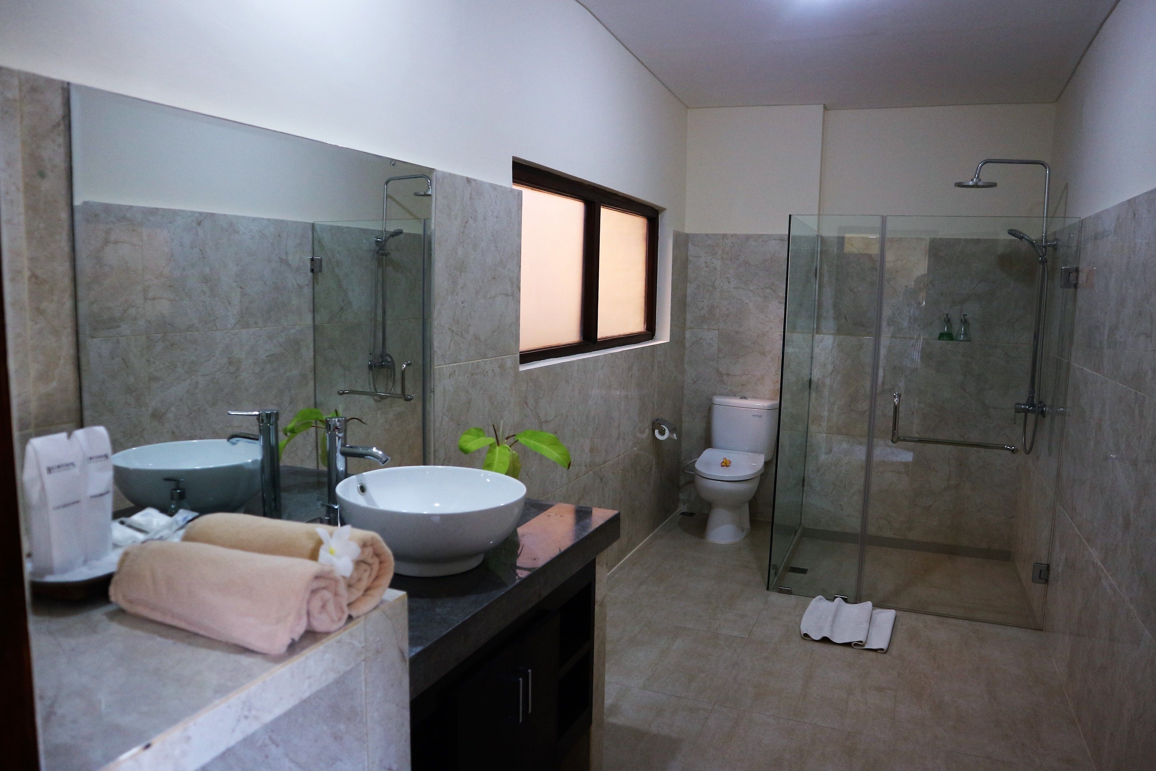 deluxe room | bathroom | slippers, towels