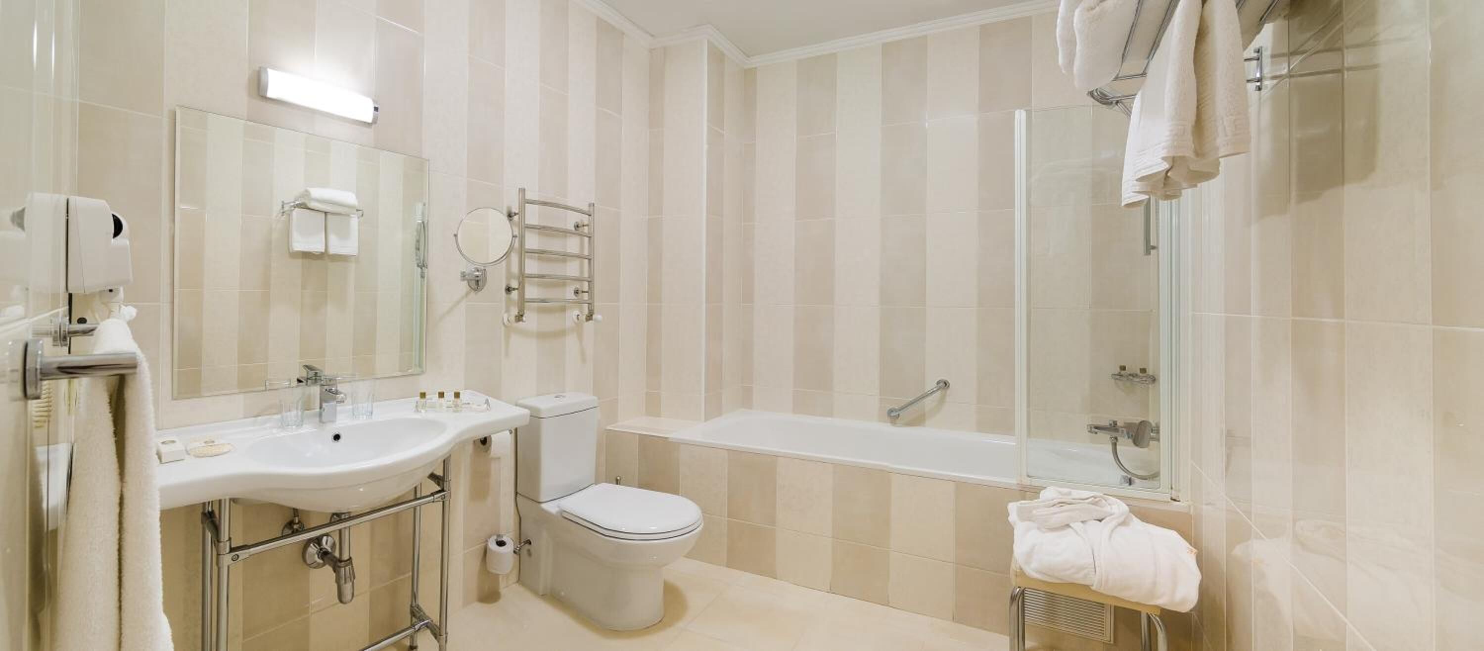 designer toiletries, hair dryer, slippers, towels