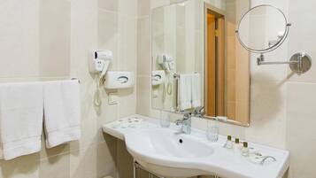 Designer toiletries, hair dryer, slippers, towels